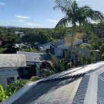 Solar pool heating panels installed on a suburban rooftop