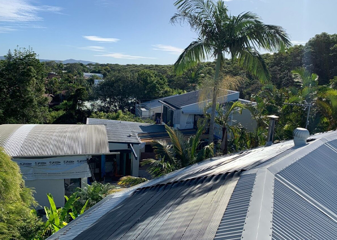 Solar pool heating panels installed on a suburban rooftop