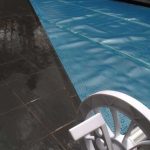 Ultra Silverback pool cover fitted over an angled backyard pool