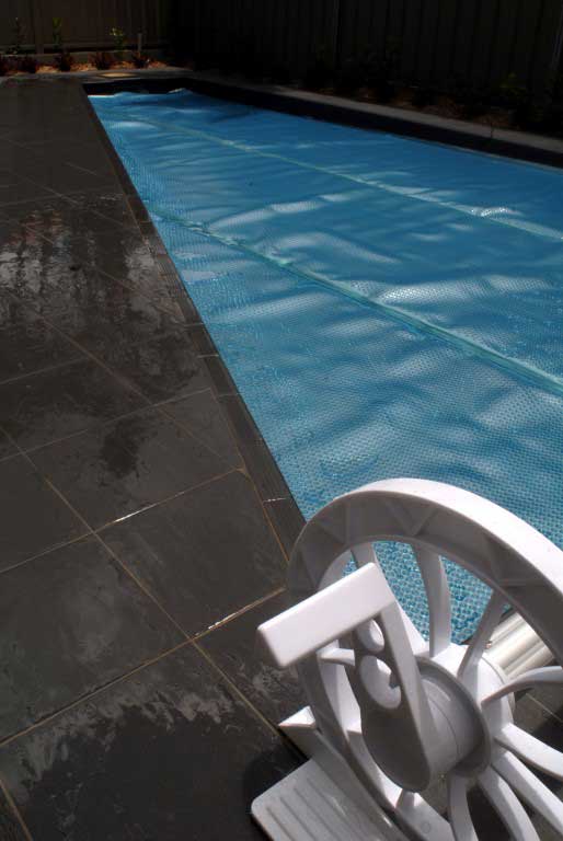 Ultra Silverback pool cover fitted over an angled backyard pool