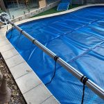 Roller bar extending the Ultra Premium Blue pool cover over the water