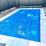 Ultra Watermark pool cover on a pool with timber fence surrounds