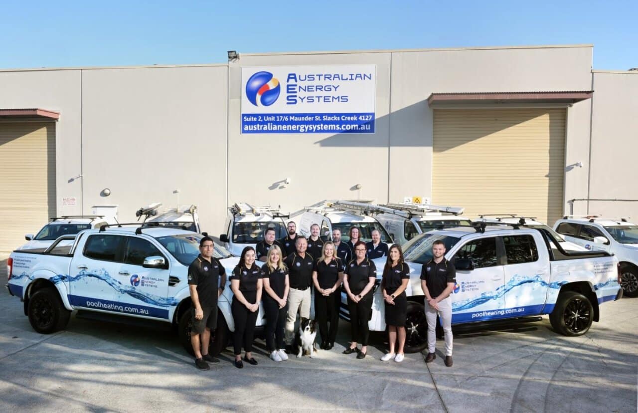 Australian Energy Systems team standing in front of branded service utes