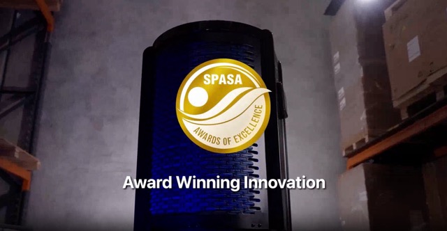 Black pool heat pump unit with SPASA Awards of Excellence badge in a warehouse