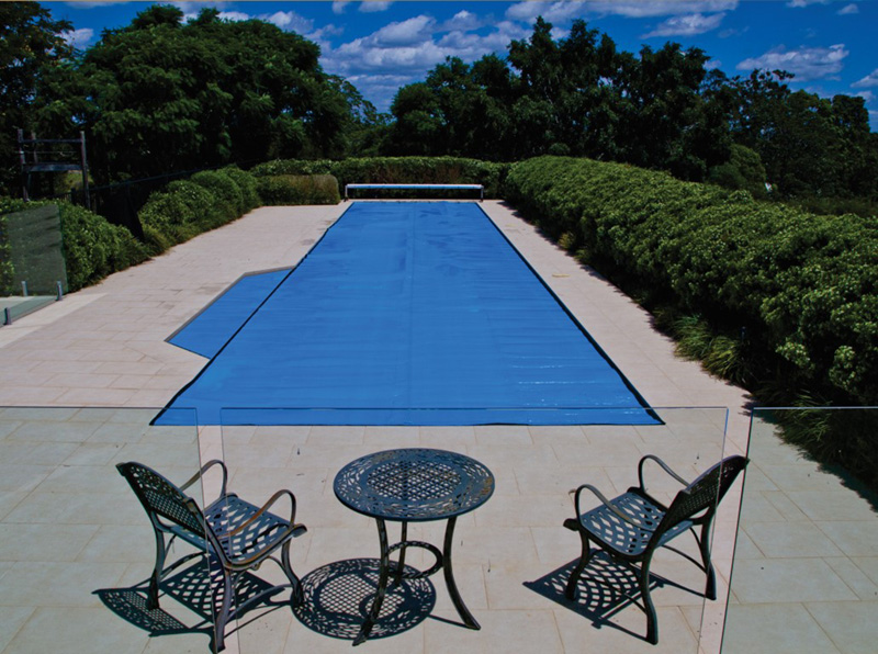 Ultra Thermal pool cover fully extended over a large outdoor pool