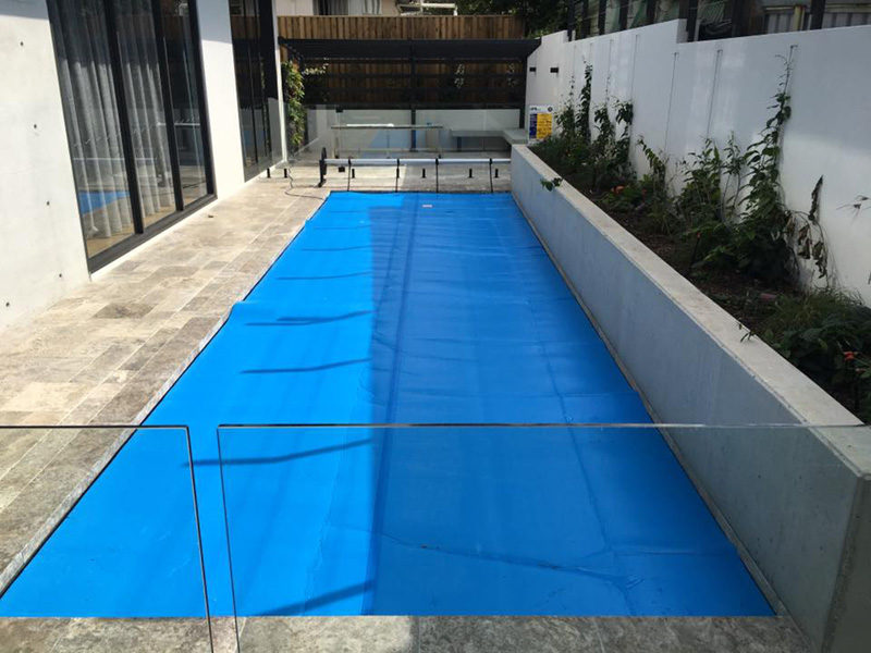 Ultra Thermal pool cover covering a small courtyard swimming pool
