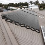 Ultra solar pool heating strips installed across a house roof